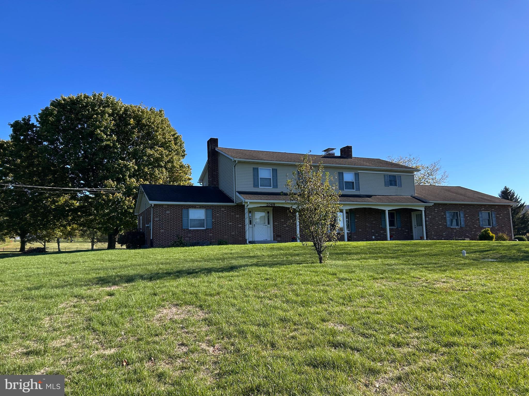 a big house with a big yard and large trees