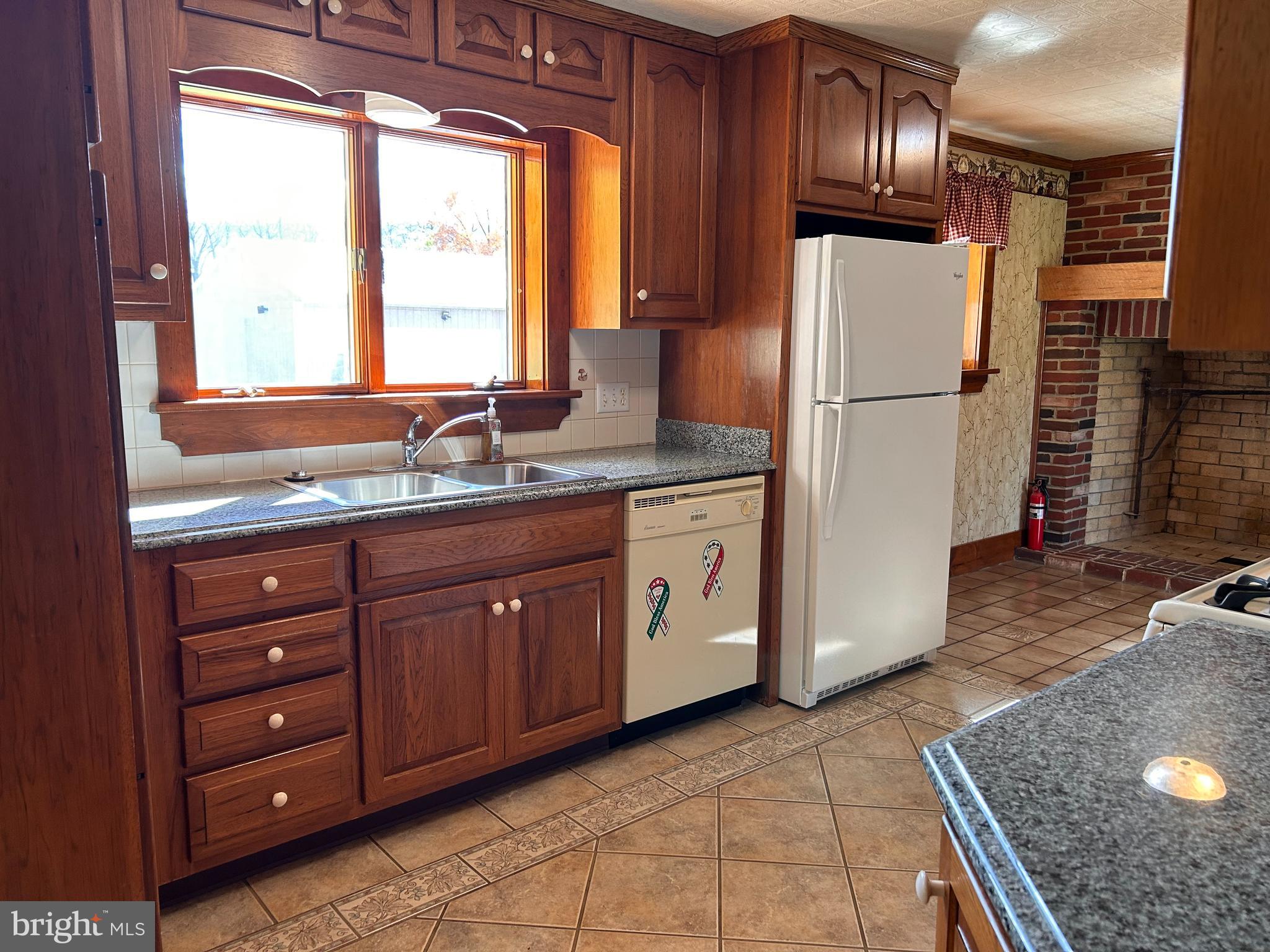2068 Earlystown Road Centre Hall, PA 16828 - Photo 16 of 62 a kitchen with a refrigerator a stove a sink and a window