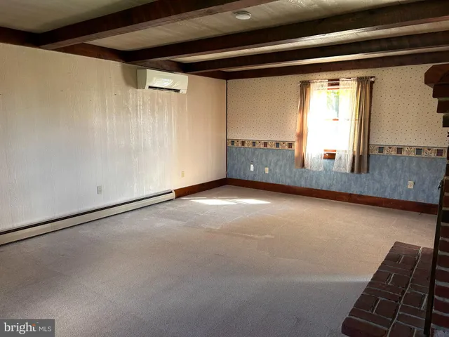 a bathroom with a granite countertop toilet sink and mirror