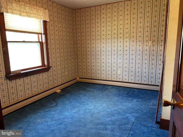 a view of an empty room and a window