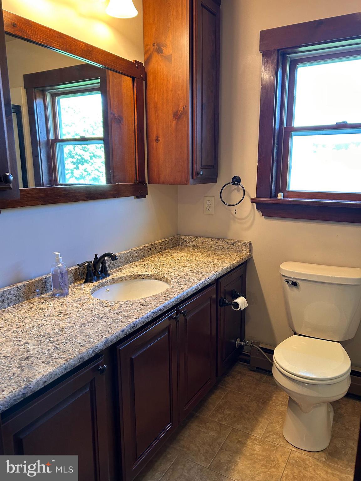 2068 Earlystown Road Centre Hall, PA 16828 - Photo 22 of 62 a bathroom with a granite countertop toilet sink and mirror