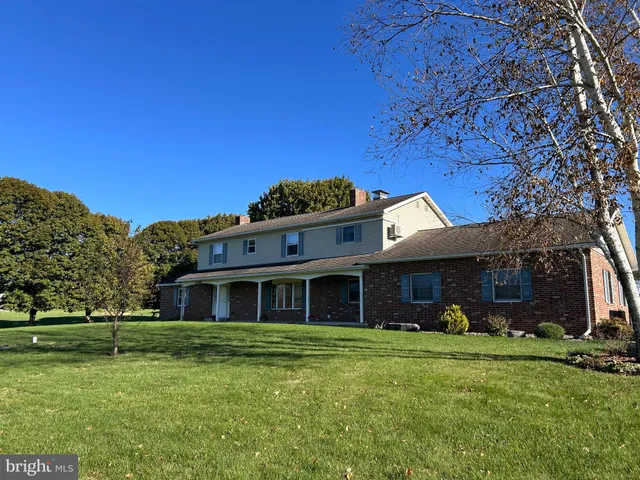 a view of a house with swimming pool and sitting area