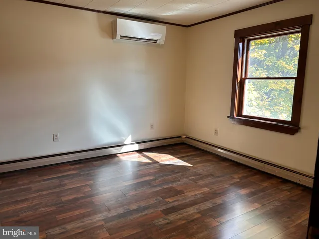 a view of an empty room with a fireplace