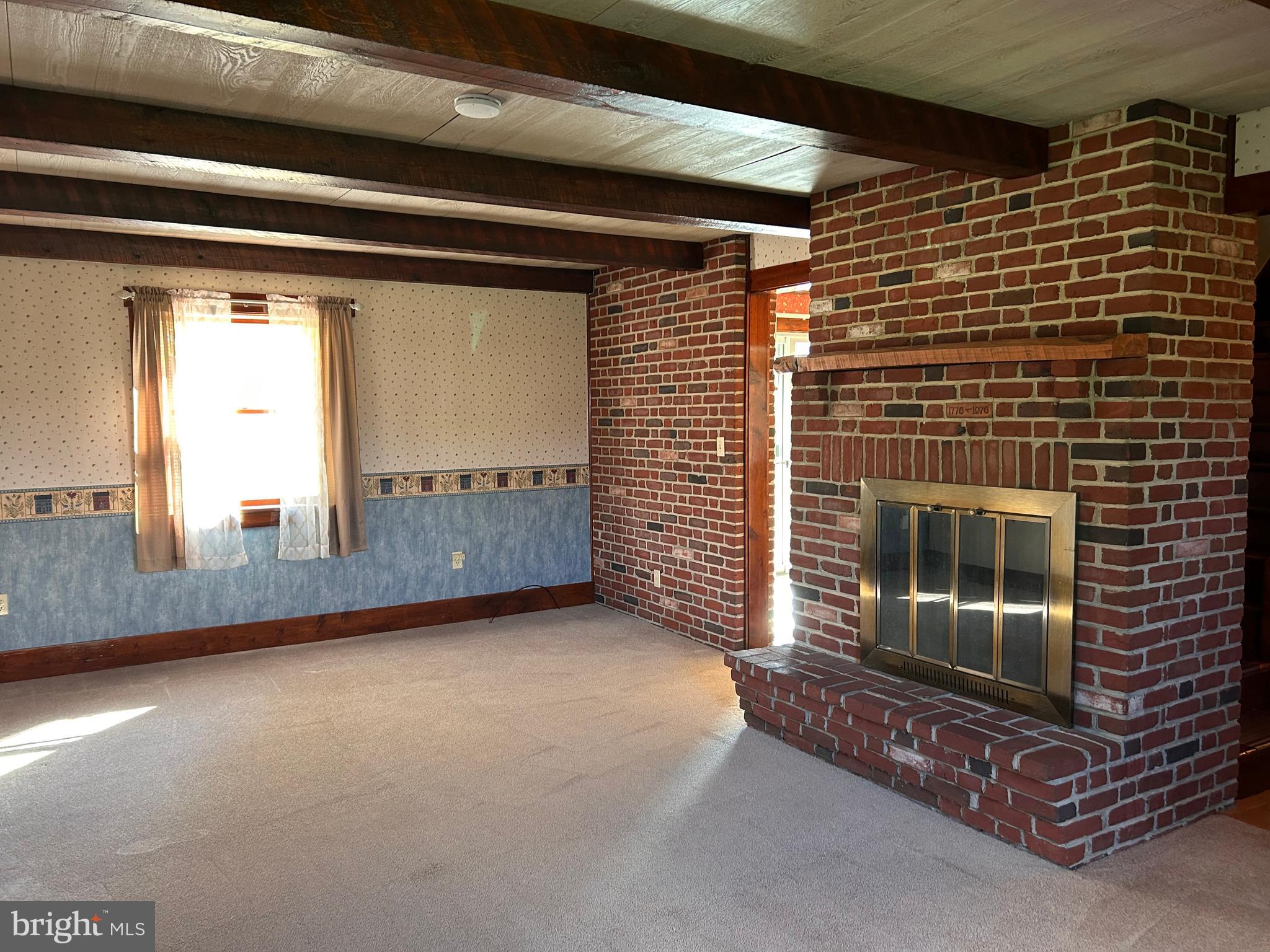 2068 Earlystown Road Centre Hall, PA 16828 - Photo 40 of 62 a view of an empty room with wooden floor and a fireplace