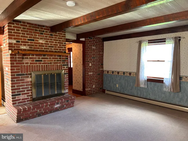 a view of a big yard with lots of green space and windows