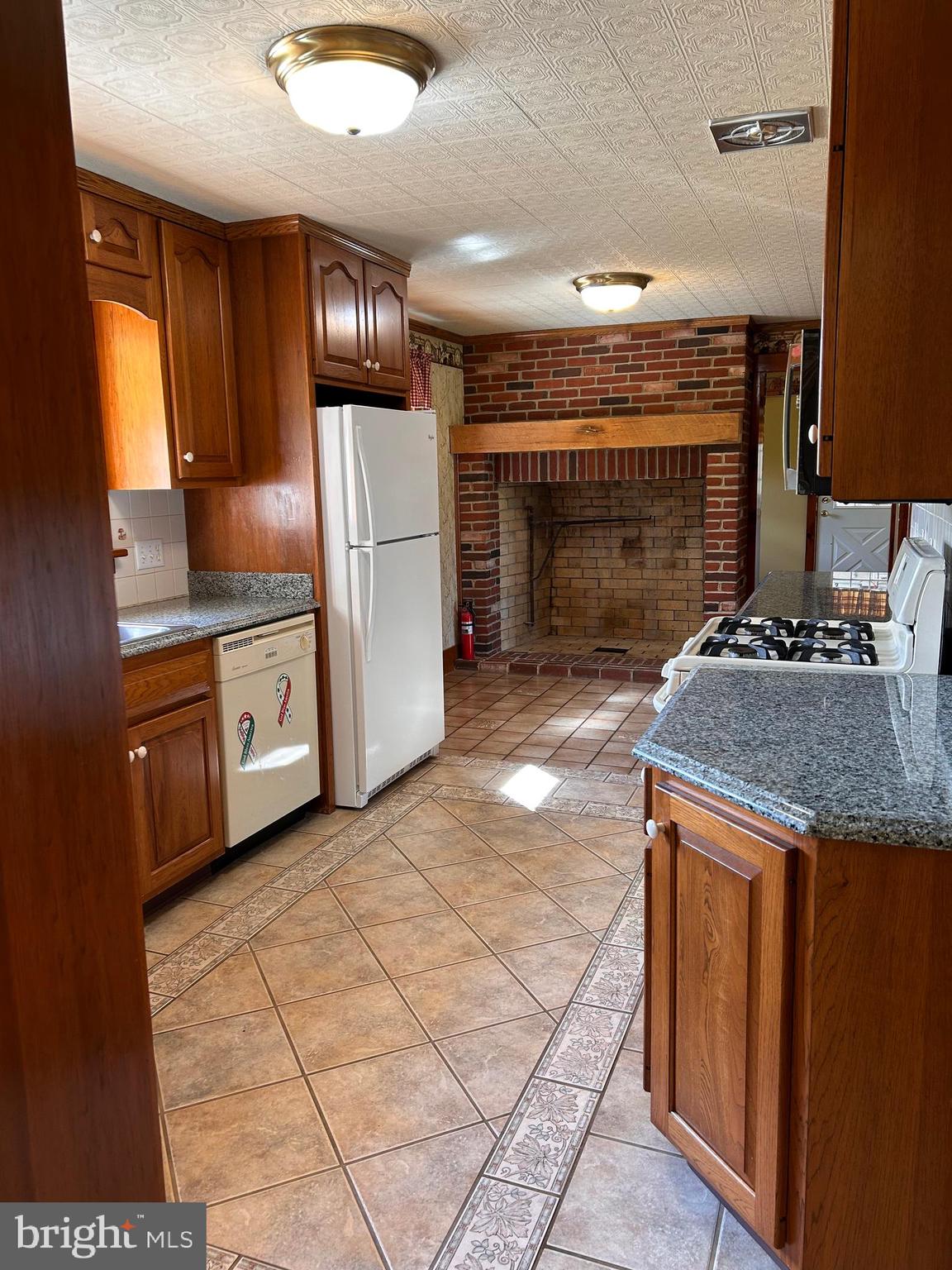 2068 Earlystown Road Centre Hall, PA 16828 - Photo 45 of 62 a kitchen with stainless steel appliances granite countertop a stove a sink and a refrigerator