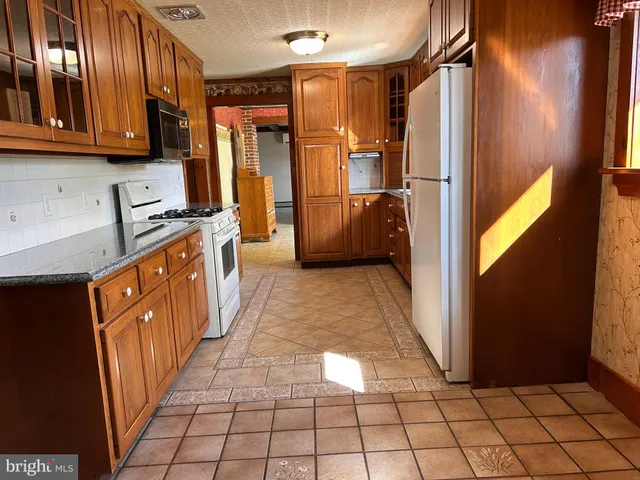 a view of a big yard with a house in the background