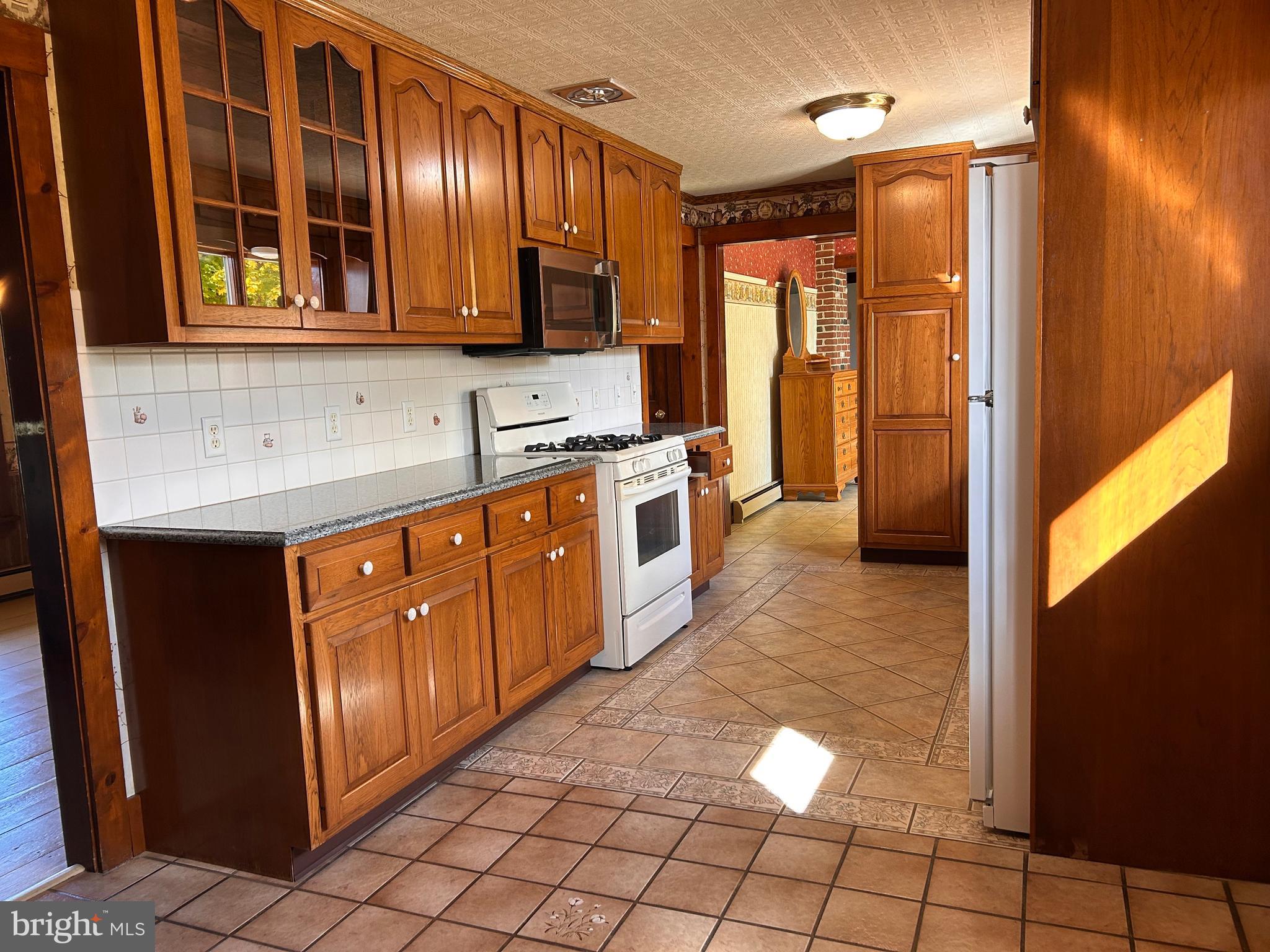 2068 Earlystown Road Centre Hall, PA 16828 - Photo 47 of 62 a kitchen with stainless steel appliances granite countertop a stove a sink and a microwave