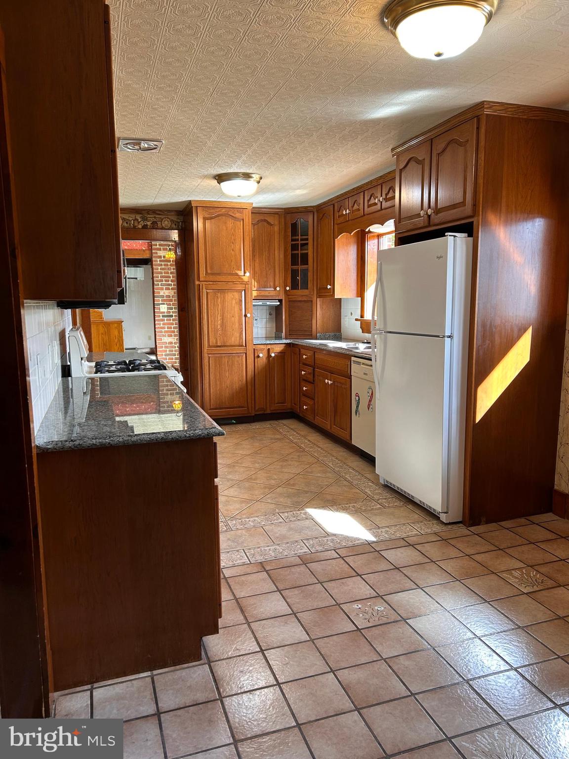 2068 Earlystown Road Centre Hall, PA 16828 - Photo 48 of 62 a kitchen with stainless steel appliances granite countertop a refrigerator a sink and a stove