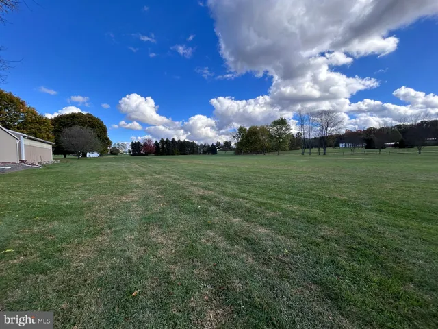 a front view of a house with a garden and yard
