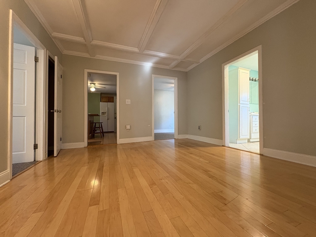 11 Franklin Street, Unit 1 Natick, MA 01760 - Photo 12 of 26 a view of empty room with wooden floor and fan