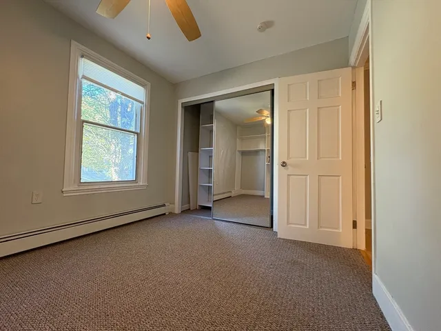 an empty room with windows and closet