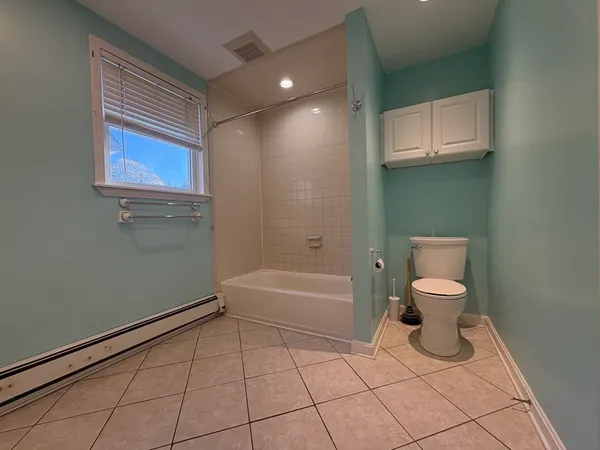 a bathroom with a toilet a sink and bathtub