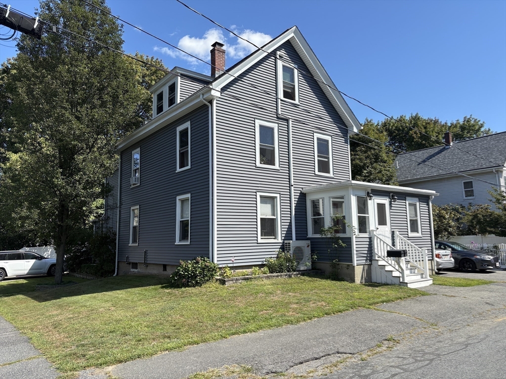 11 Franklin Street, Unit 1 Natick, MA 01760 - Photo 26 of 26 a front view of a house with garden