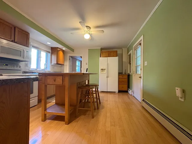 a view of a dining room with furniture and a chandelier