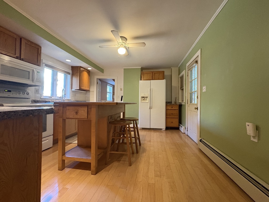 11 Franklin Street, Unit 1 Natick, MA 01760 - Photo 6 of 26 a view of a dining room with furniture and a chandelier