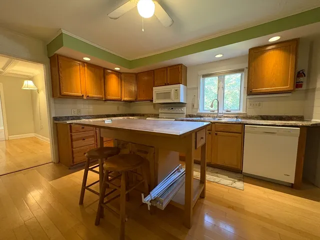 a kitchen with a stove a sink and a refrigerator