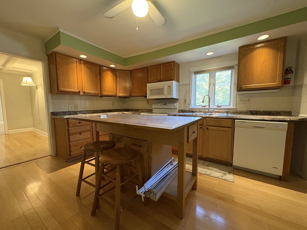 11 Franklin Street, Unit 1 Natick, MA 01760 - Photo 9 of 26 a kitchen with a stove a sink and a refrigerator
