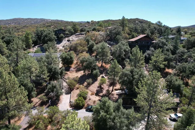an aerial view of house with yard and outdoor seating