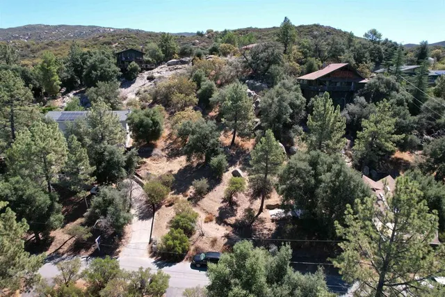an aerial view of a house with a yard and outdoor seating