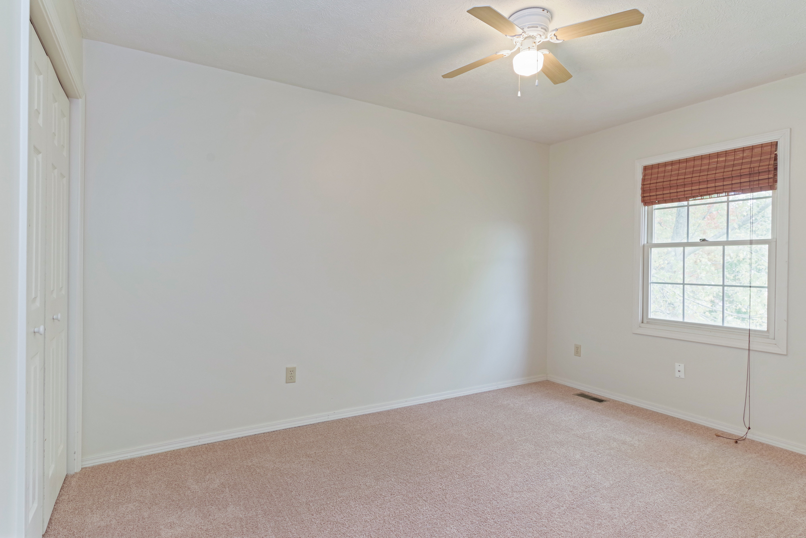 116 North Blair Drive Normal, IL 61761 - Photo 29 of 41 an empty room with a window and a fan