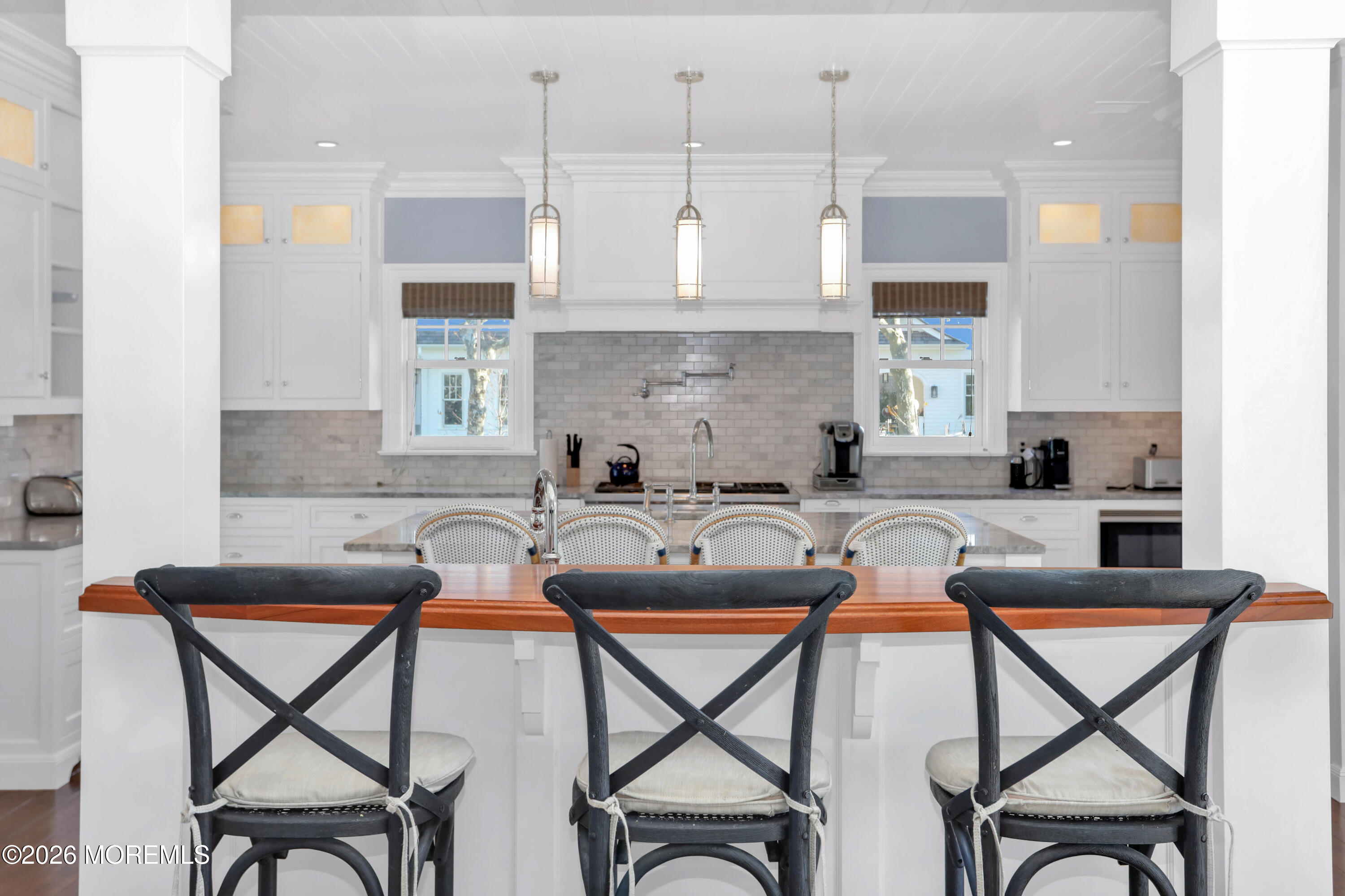 101 Tuttle Avenue Spring Lake, NJ 07762 - Photo 12 of 62 a kitchen with stainless steel appliances granite countertop table chairs sink and cabinets