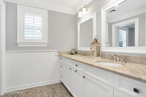 a bathroom with a toilet a sink and a mirror