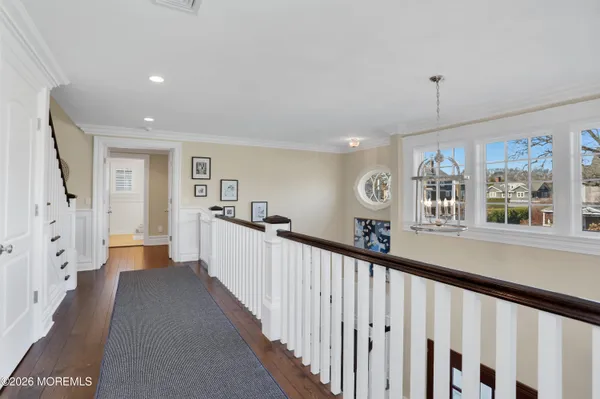 a living room with furniture kitchen view and a flat screen tv