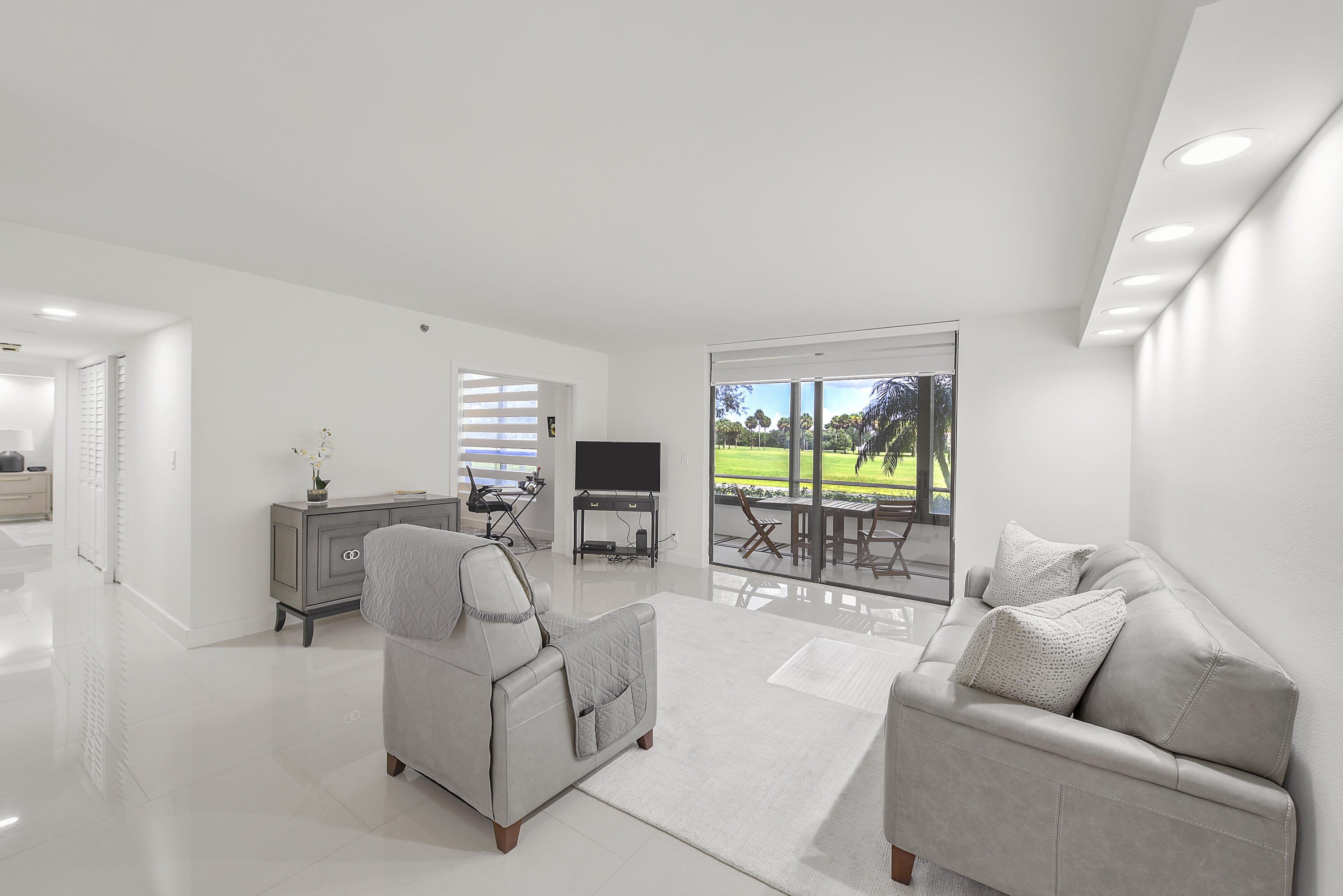7145 Promenade Drive, Unit 101 Boca Raton, FL 33433 - Photo 2 of 24 a living room with furniture and a large window