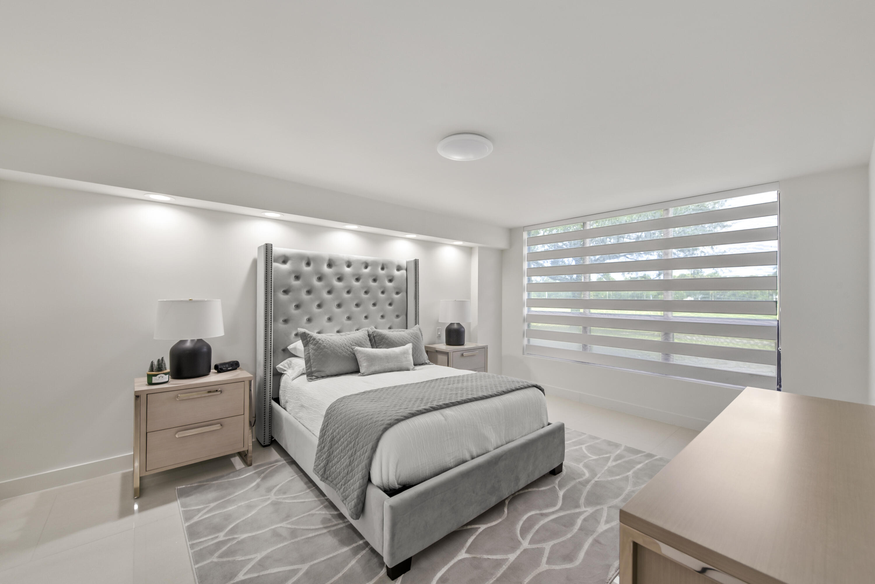 7145 Promenade Drive, Unit 101 Boca Raton, FL 33433 - Photo 7 of 24 a large bedroom with a bed and large window