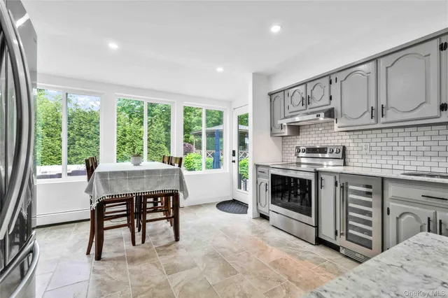 a kitchen with microwave a stove and furniture