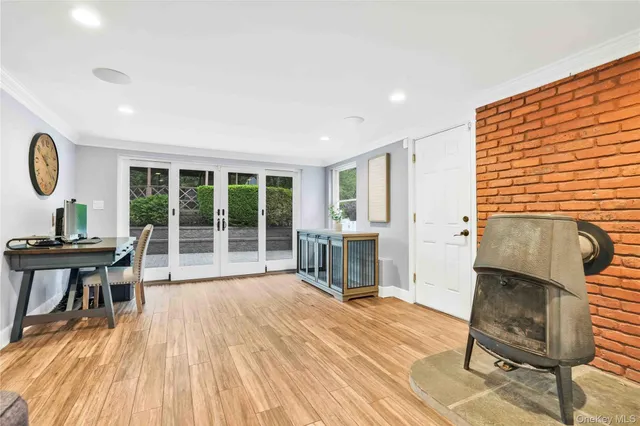 a view of a workspace with furniture and a window