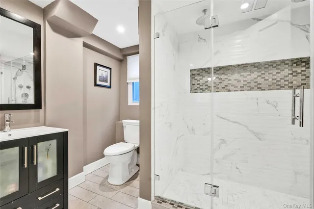 a bathroom with a toilet sink and a shower