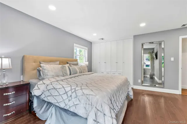 a bedroom with a large bed and a chandelier