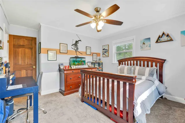 a bedroom with furniture and a large window