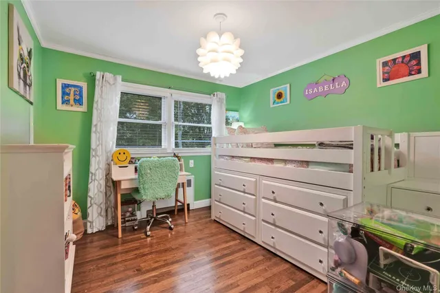 a view of a bedroom with a bed and a window