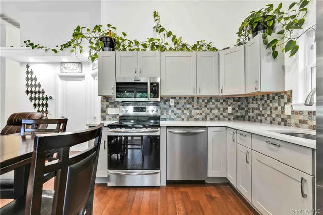 a kitchen with appliances a sink and cabinets