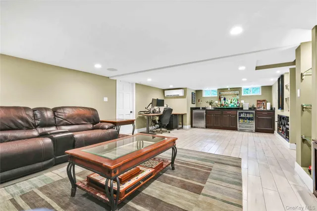 a living room with furniture and view of kitchen