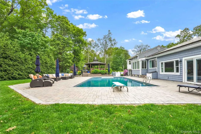 a view of a house with backyard porch and sitting area