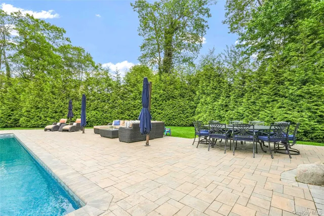 a view of a backyard with sitting area