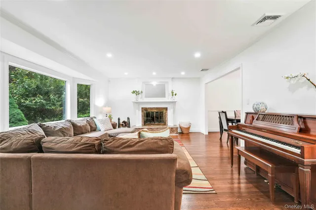 a living room with furniture fireplace and a large window