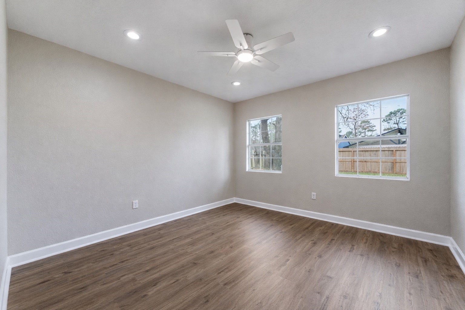 19711 Bishops Gate Lane Humble, TX 77338 - Photo 11 of 12 Another bedroom overlooking the backyard, featuring updated flooring, recessed lighting, and great natural light, quiet, comfortable for any use.
