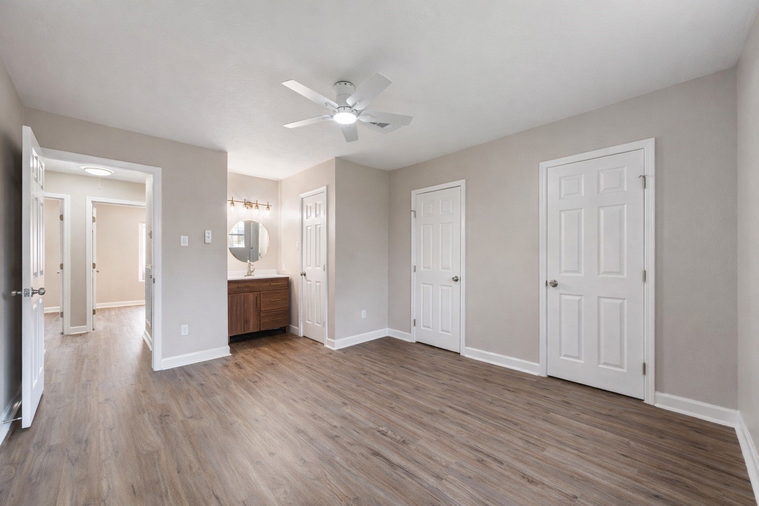 19711 Bishops Gate Lane Humble, TX 77338 - Photo 6 of 12 Generous primary with updated flooring and direct access to the vanity area.