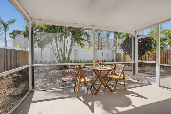 a view of a patio with a table and chairs