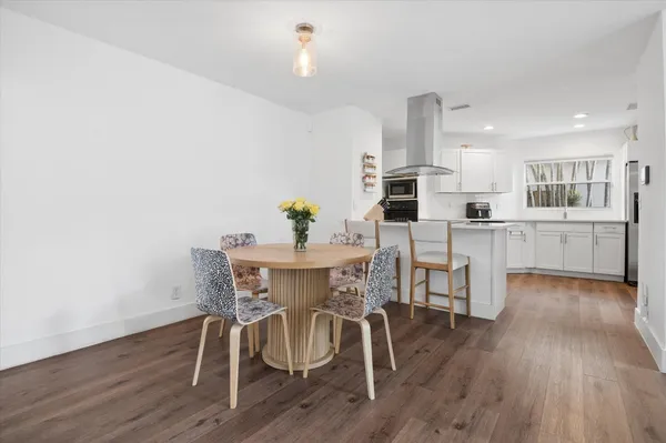 a view of a dining room with furniture and wooden floor