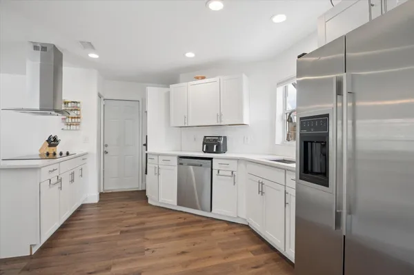a kitchen with cabinets and stainless steel appliances