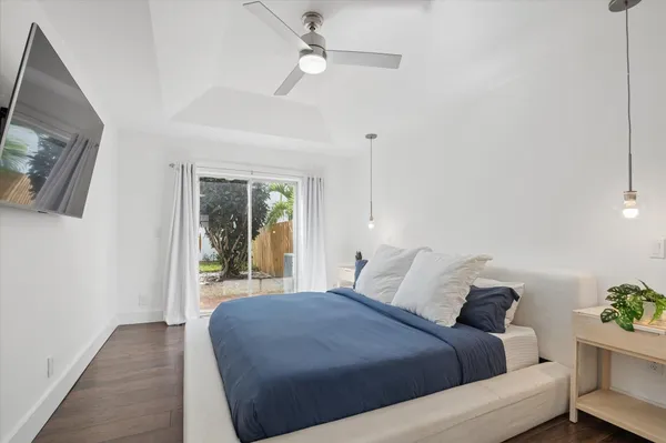 a bedroom with a large bed and a chandelier