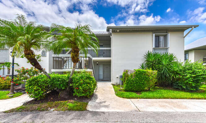Undisclosed Address Stuart, FL 34994 - Photo 1 of 41 a front view of a house with garden