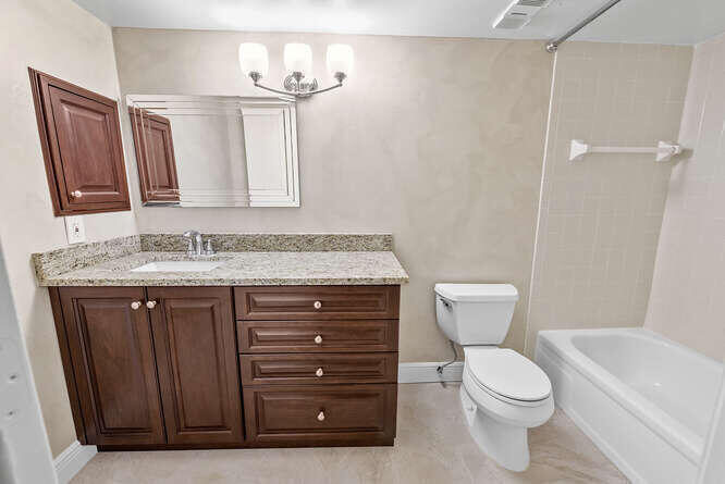 Undisclosed Address Stuart, FL 34994 - Photo 16 of 41 a bathroom with a granite countertop sink toilet and mirror