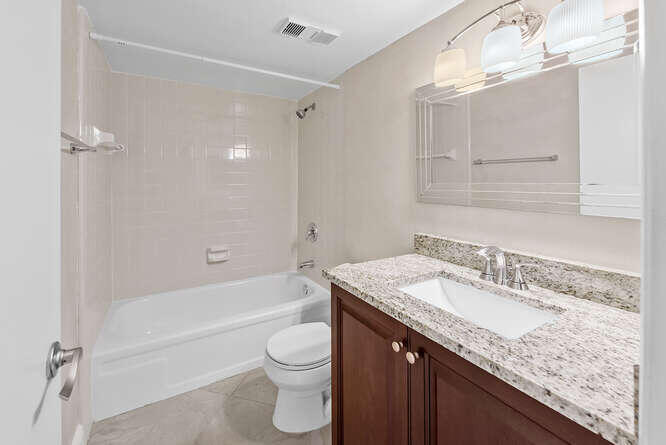 Undisclosed Address Stuart, FL 34994 - Photo 18 of 41 a bathroom with a granite countertop sink a toilet and bathtub